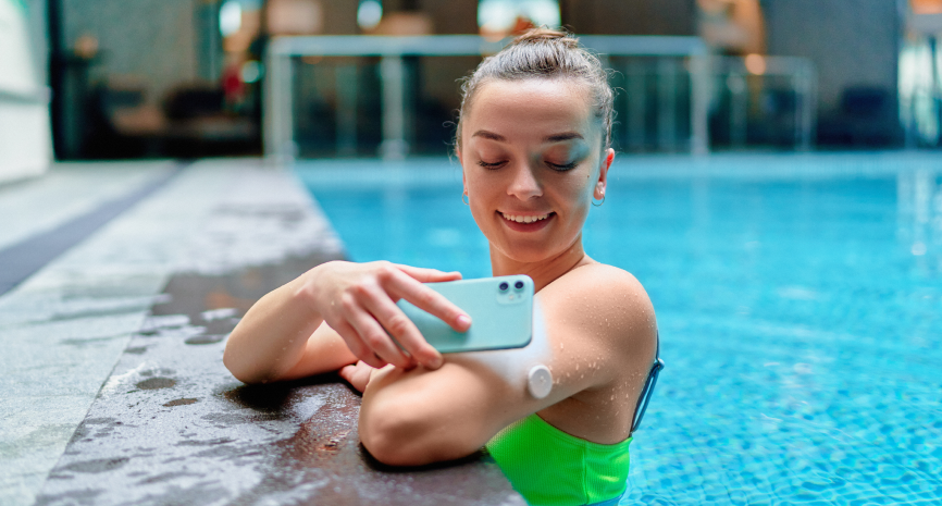 woman with her phone in the pool