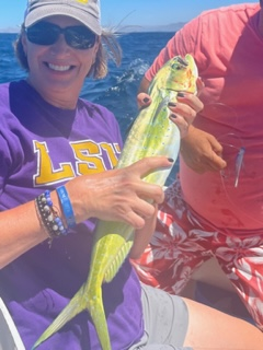 Photo of Angela holding a caught mahi